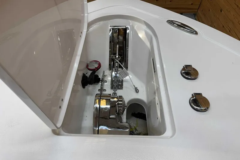 Slide: The Image of 2025 Tidewater 232 CC Adventure boat anchor compartment with stainless steel fittings. - 13