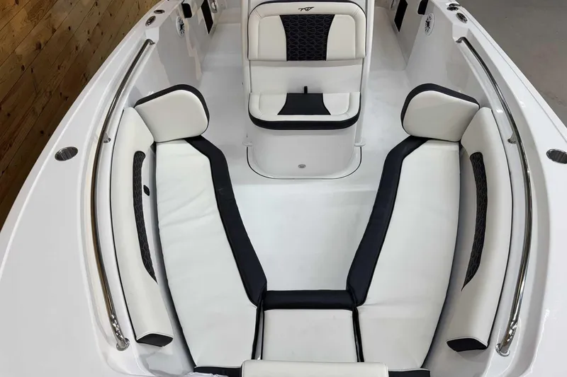 Slide: The Image of 2025 Tidewater 232 CC Adventure boat interior with white and black cushioned seating. - 14