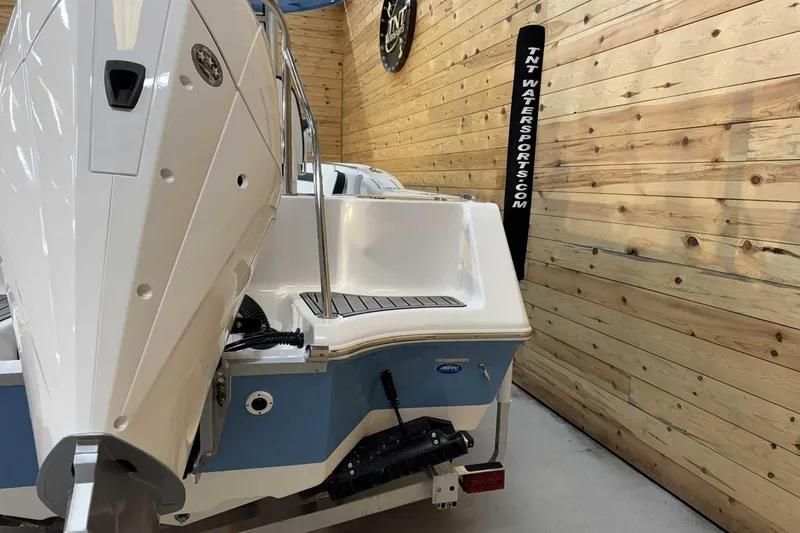 Slide: The Image of 2025 Tidewater 232 CC Adventure boat in showroom with wooden walls. - 3
