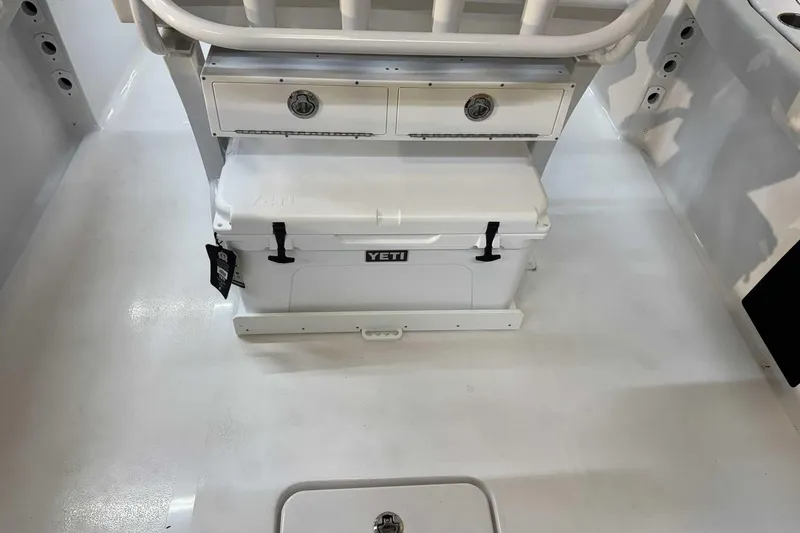 Slide: The Image of 2025 Tidewater 232 CC Adventure boat interior with Yeti cooler and storage drawers. - 8