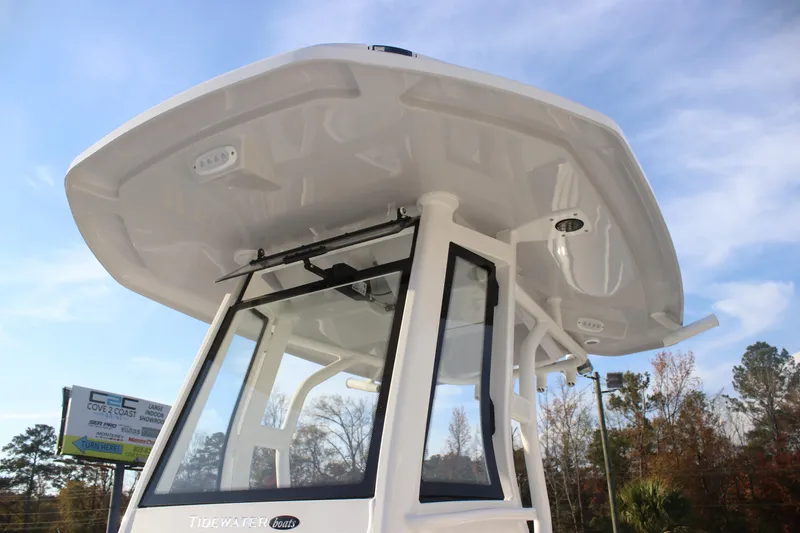 Slide: The Image of 2026 Tidewater 2500 Carolina Bay boat console with steering wheel and controls. - 11