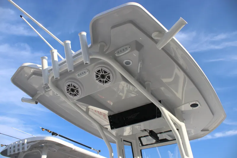 Slide: The Image of 2026 Tidewater 2500 Carolina Bay boat, featuring a sleek T-top design against a clear sky. - 16