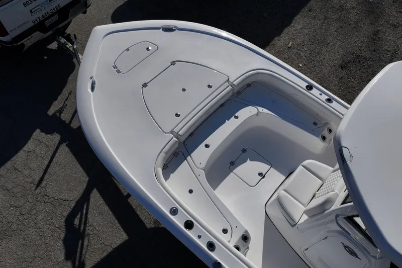 Slide: The Image of 2026 Tidewater 2500 Carolina Bay boat on trailer, parked outdoors. - 2