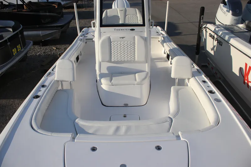 Slide: The Image of 2026 Tidewater 2500 Carolina Bay boat interior with white seating and spacious deck layout. - 24
