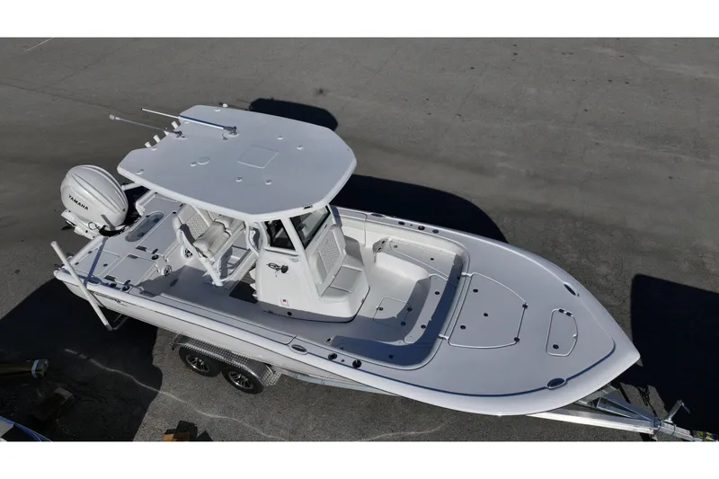 Slide: The Image of 2026 Tidewater 2500 Carolina Bay boat on trailer, parked near a scenic lake. - 3