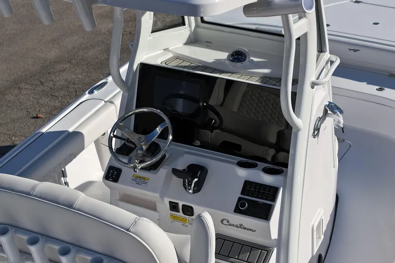 Slide: The Image of 2026 Tidewater 2500 Carolina Bay boat on trailer at dealership, featuring Yamaha engine. - 6