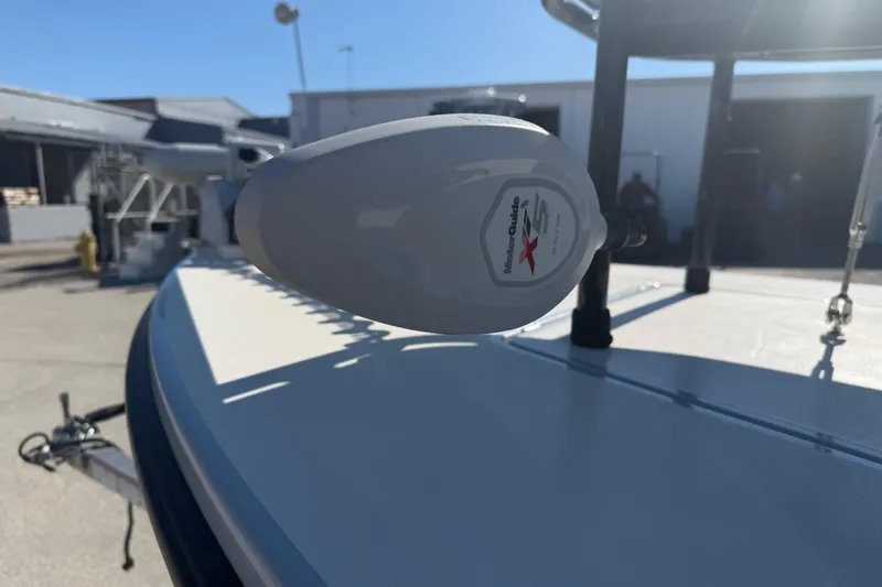 Slide: The Image of 2020 Maverick 18 HPX-V boat with MotorGuide trolling motor in a sunny outdoor setting. - 17