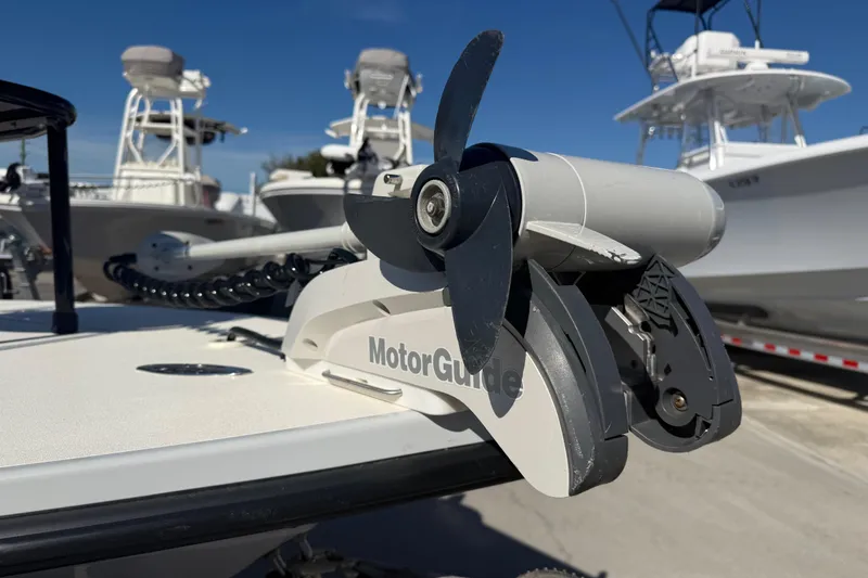 Slide: The Image of 2020 Maverick 18 HPX-V with MotorGuide trolling motor, docked under clear blue sky. - 19