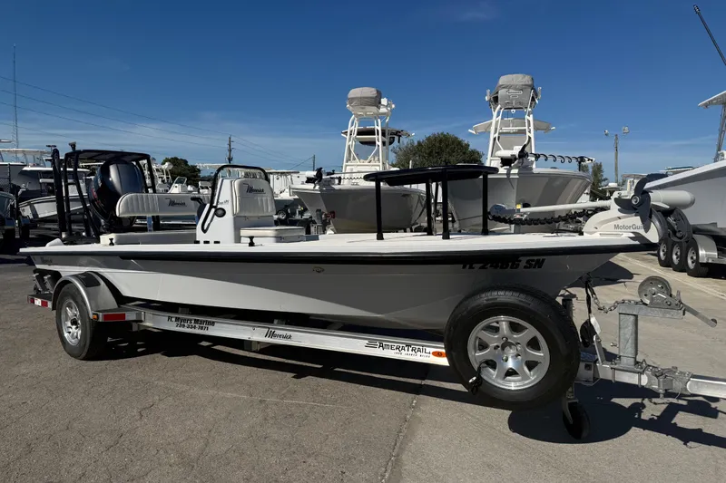 Slide: The Image of 2020 Maverick 18 HPX-V boat on trailer in marina under clear blue sky. - 20
