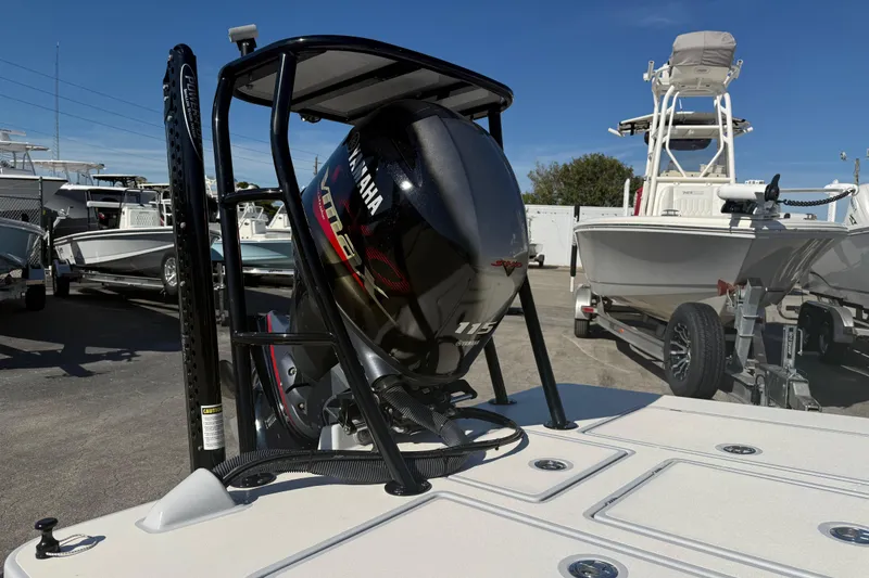 Slide: The Image of 2020 Maverick 18 HPX-V boat with Yamaha 115 engine in a marina setting. - 8