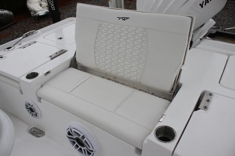 Slide: The Image of 2026 Tidewater 2500 Carolina Bay boat with white cushioned seating and cup holders. - 10
