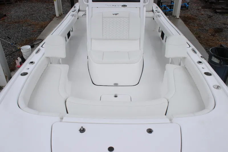 Slide: The Image of 2026 Tidewater 2500 Carolina Bay boat interior with white seating and spacious layout. - 16