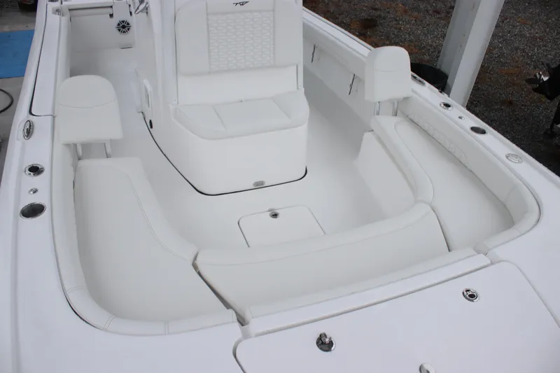 Slide: The Image of 2026 Tidewater 2500 Carolina Bay boat interior with white seating and spacious layout. - 9