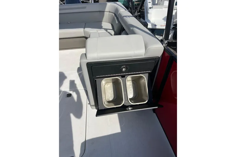 Slide: The Image of 2026 Hurricane FunDeck 2260 REF OB boat interior with storage compartment and seating. - 11