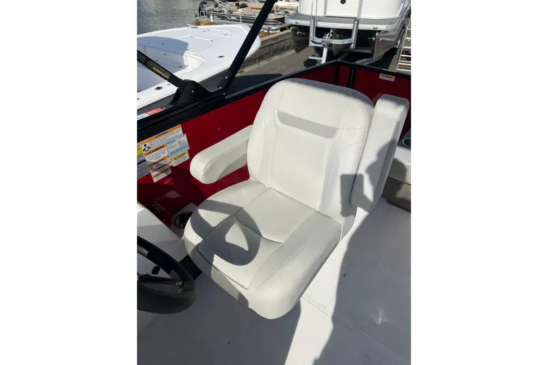 Slide: The Image of White captain's chair on 2026 Hurricane FunDeck 2260 REF OB boat, dockside view. - 12