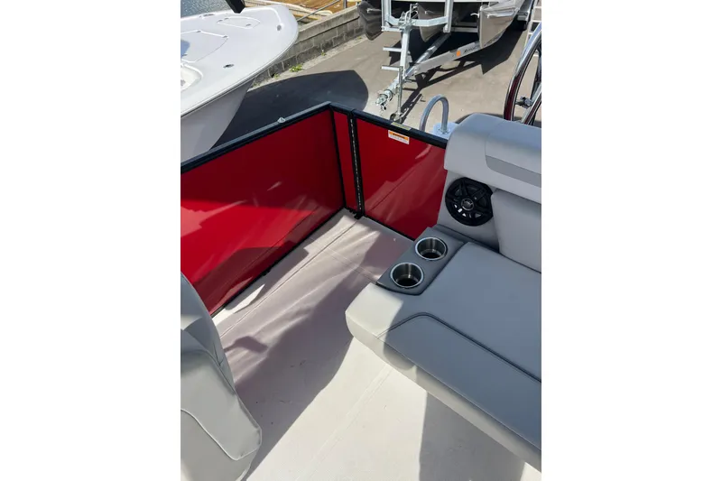 Slide: The Image of 2026 Hurricane FunDeck 2260 REF OB interior with red panel, gray seating, and cup holders. - 16