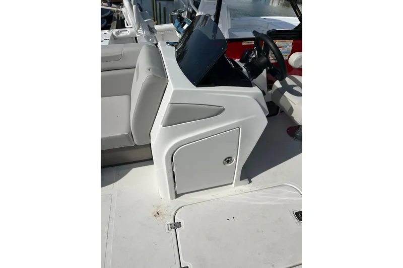 Slide: The Image of 2026 Hurricane FunDeck 2260 REF OB boat interior with steering console and seating. - 22