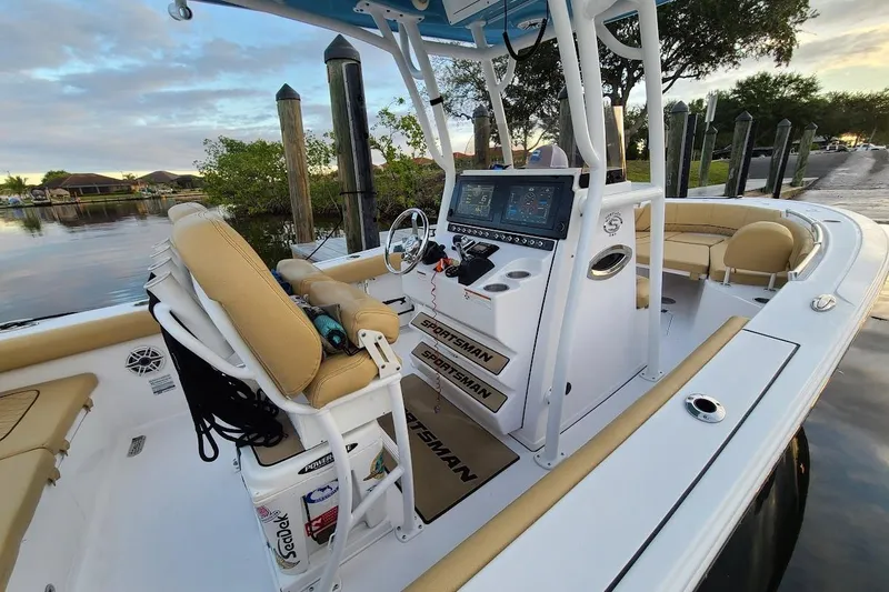 Slide: The Image of 2019 Sportsman Heritage 241 Center Console boat with tan seating and white deck. - 10