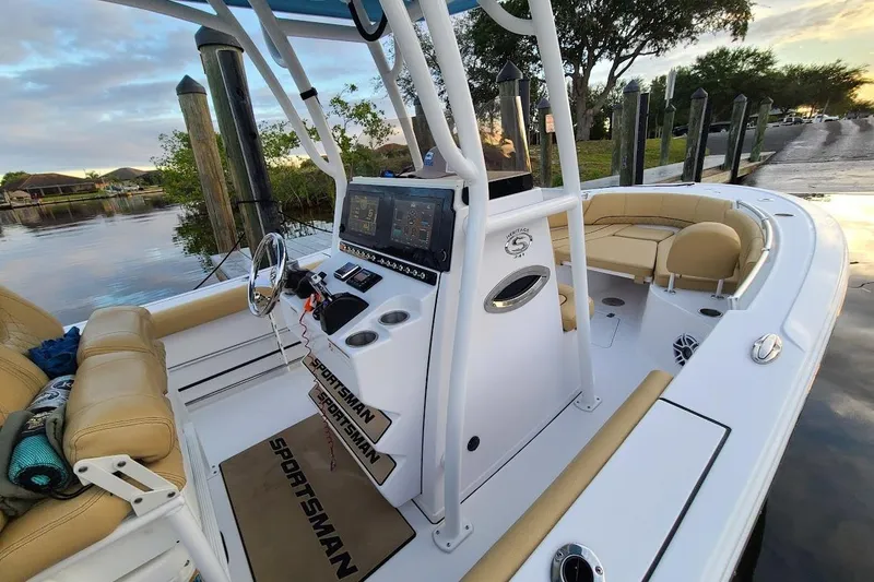 Slide: The Image of 2019 Sportsman Heritage 241 Center Console boat at dock, featuring modern navigation equipment. - 11