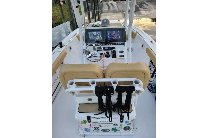 Slide: The Image of 2019 Sportsman Heritage 241 Center Console boat with tan seating and modern dashboard. - 12