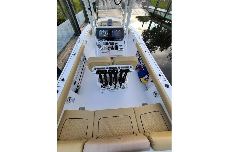 Slide: The Image of 2019 Sportsman Heritage 241 Center Console boat interior with dual screens and beige seating. - 14