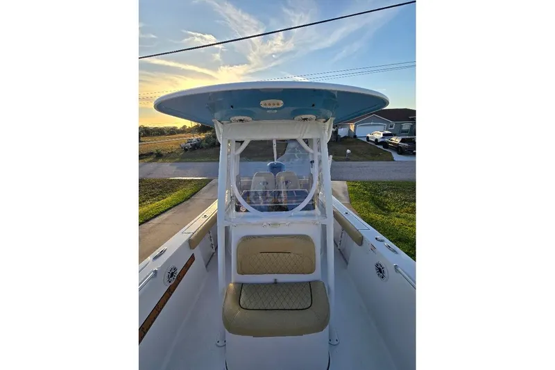Slide: The Image of 2019 Sportsman Heritage 241 Center Console boat with seating, viewed from the deck at sunset. - 21