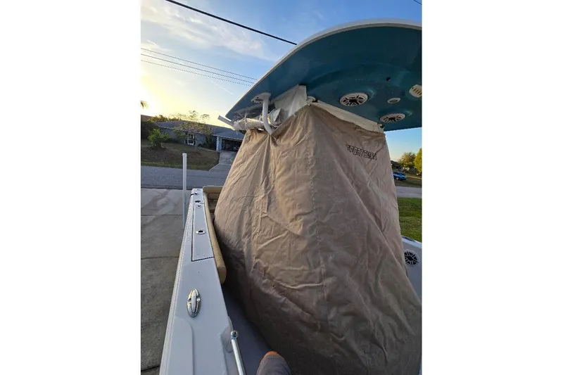 Slide: The Image of 2019 Sportsman Heritage 241 Center Console boat with protective cover in driveway. - 31