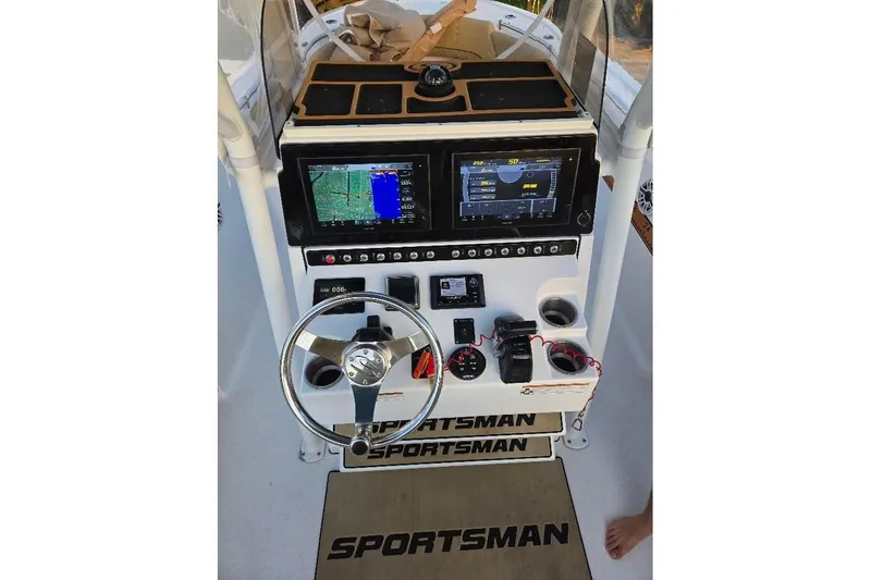 Slide: The Image of 2019 Sportsman Heritage 241 Center Console dashboard with navigation screens and controls. - 34