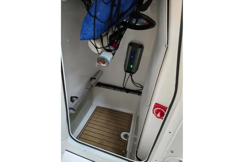 Slide: The Image of Interior of 2019 Sportsman Heritage 241 Center Console boat, featuring storage and equipment. - 38
