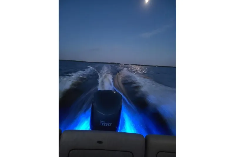 Slide: The Image of 2019 Sportsman Heritage 241 Center Console boat cruising at night with illuminated wake. - 39