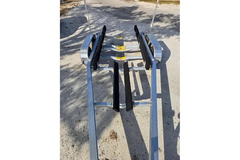 Slide: The Image of Trailer for 2019 Sportsman Heritage 241 Center Console boat on sandy ground. - 41