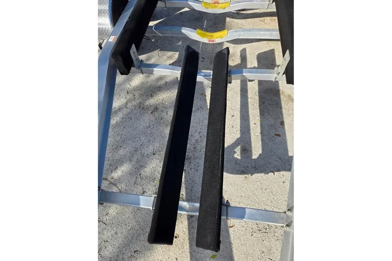 Slide: The Image of Trailer for 2019 Sportsman Heritage 241 Center Console boat, showing support beams. - 43