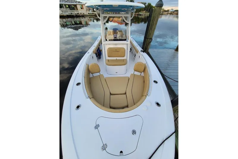 Slide: The Image of 2019 Sportsman Heritage 241 Center Console boat on trailer, parked beside a truck. - 6