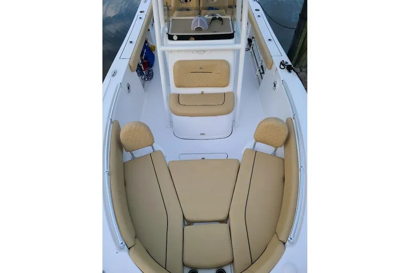 Slide: The Image of 2019 Sportsman Heritage 241 Center Console boat docked, featuring spacious seating and sleek design. - 8