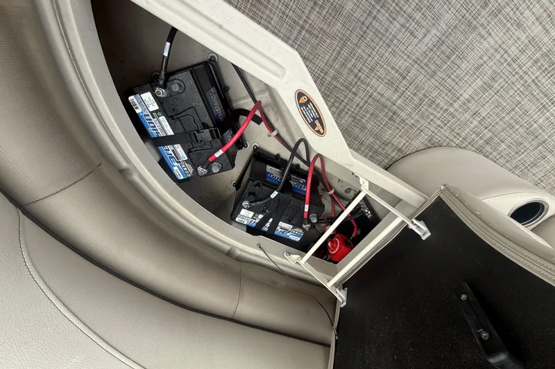 Slide: The Image of Battery compartment of 2023 Cypress Cay Seabreeze 232 pontoon boat, featuring multiple batteries. - 12