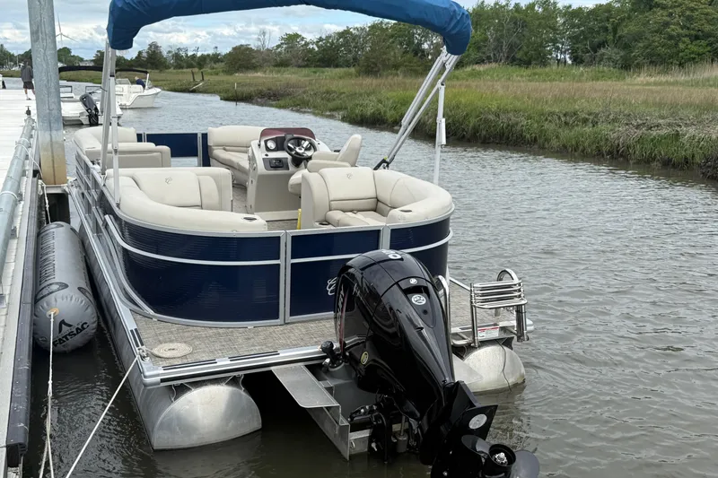 Slide: The Image of 2023 Cypress Cay Seabreeze 232 pontoon boat docked on a calm river. - 3