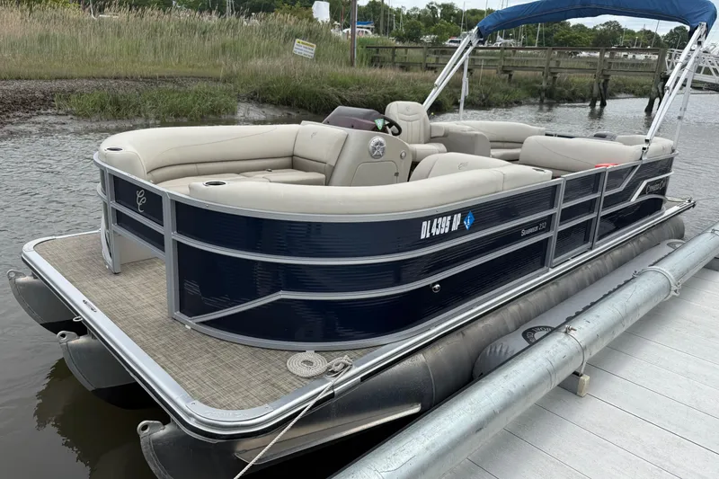 Slide: The Image of 2023 Cypress Cay Seabreeze 232 pontoon boat docked on a calm waterway. - 4