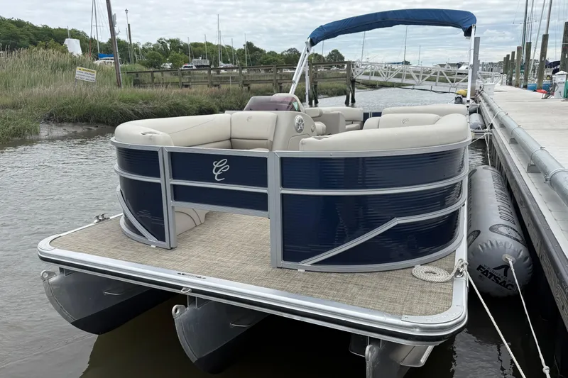 Slide: The Image of 2023 Cypress Cay Seabreeze 232 pontoon boat docked by the water. - 5