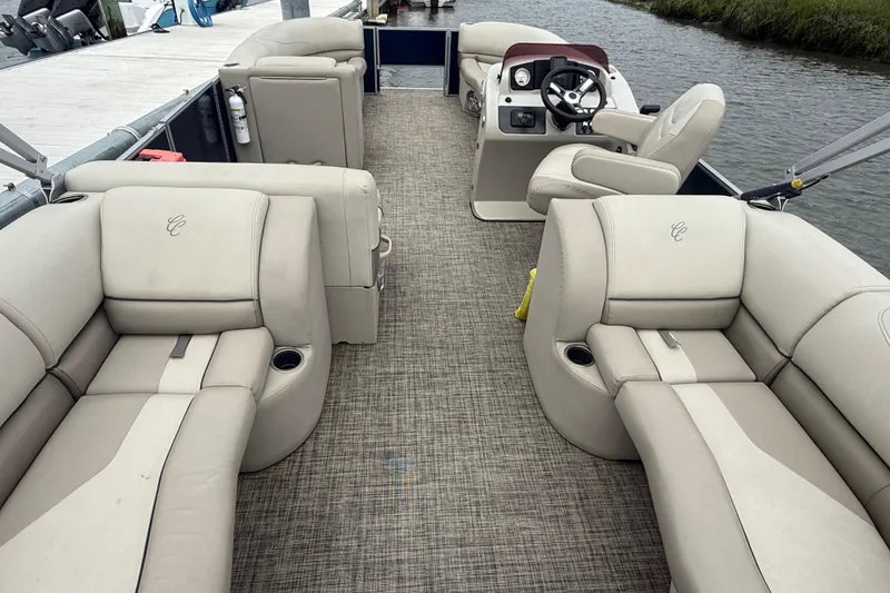 Slide: The Image of 2023 Cypress Cay Seabreeze 232 pontoon boat interior with beige seating and steering console. - 6