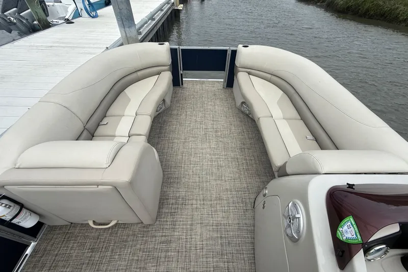 Slide: The Image of 2023 Cypress Cay Seabreeze 232 pontoon boat interior with beige seating and carpet flooring. - 9