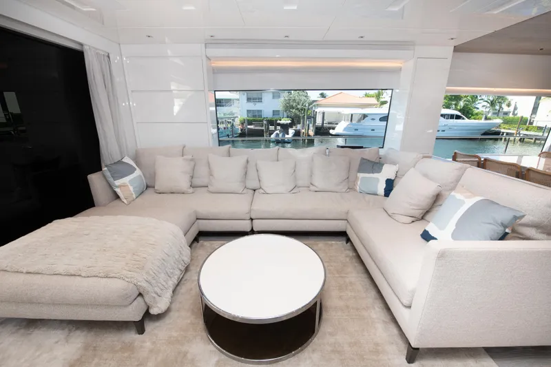 Slide: The Image of Luxurious Sanlorenzo SL78 2022 yacht interior with plush beige sectional sofa and round coffee table. - 18