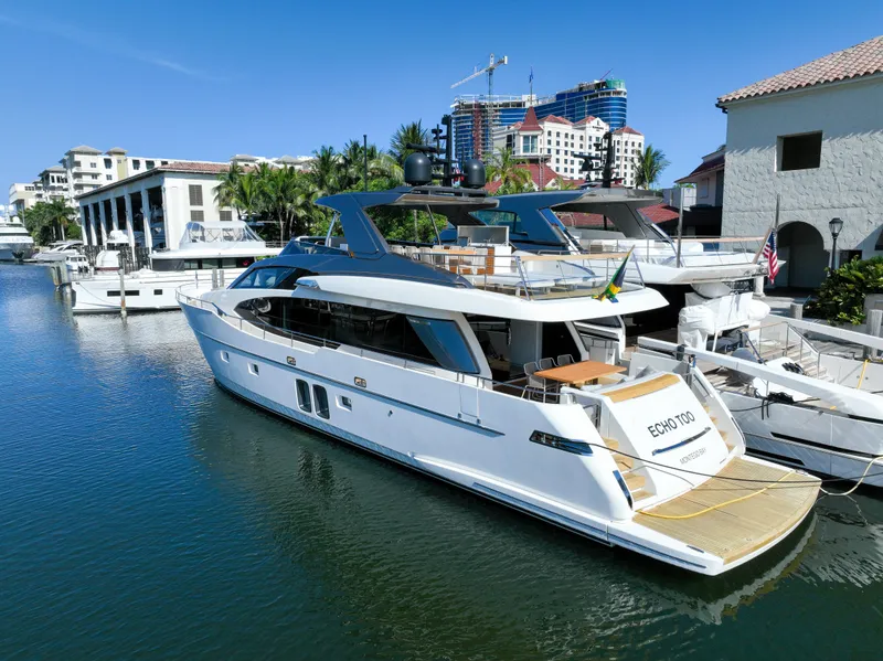 Slide: The Image of Sanlorenzo SL78 2022 yacht docked in a marina, surrounded by buildings and clear blue sky. - 3