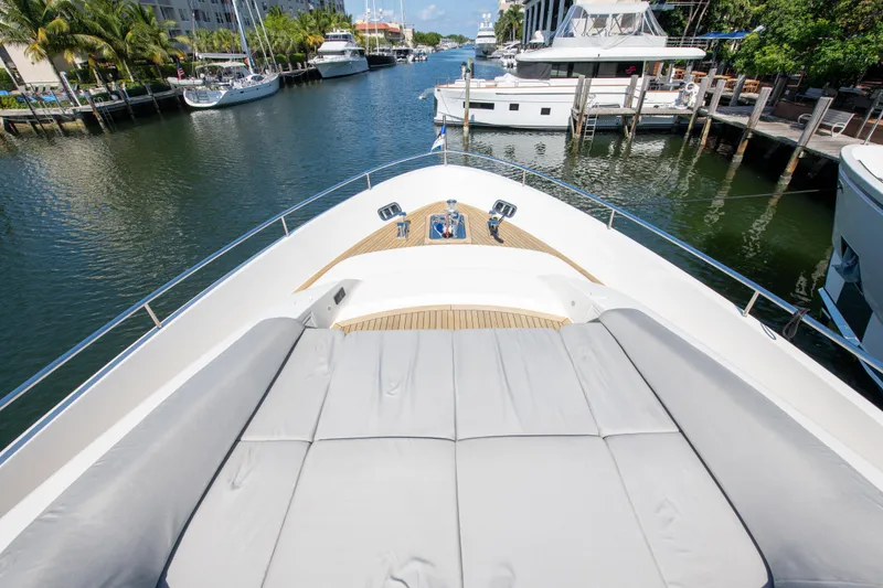 Slide: The Image of Sanlorenzo SL78 2022 yacht bow view, featuring spacious sunbathing area in a marina setting. - 5