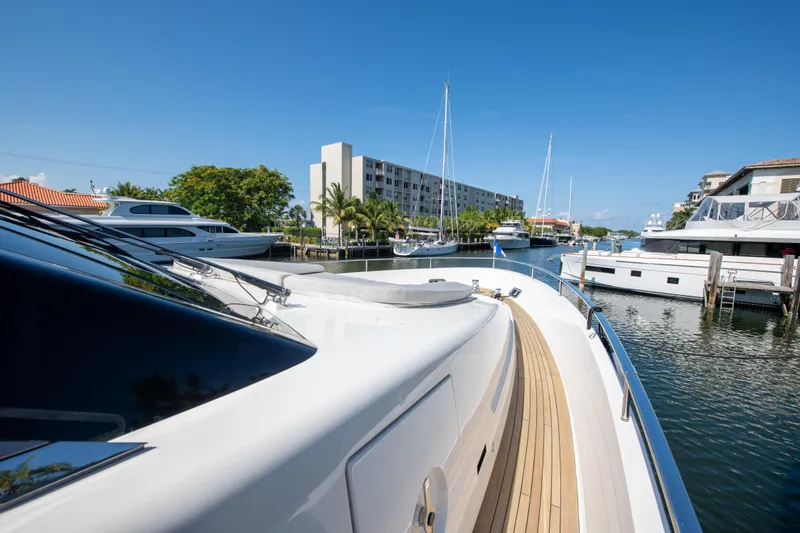 Slide: The Image of Sanlorenzo SL78 yacht, 2022 model, docked in a marina with clear blue skies. - 6