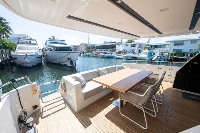 Slide: The Image of Outdoor seating area on a 2022 Sanlorenzo SL78 yacht, docked at a marina. - 7