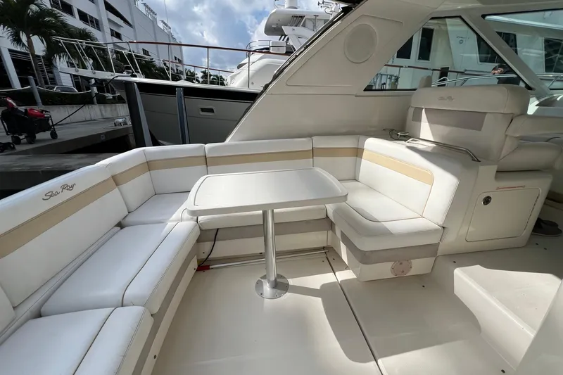 Slide: The Image of Luxurious 2010 Sea Ray 450 Sundancer yacht interior with elegant seating and table. - 12