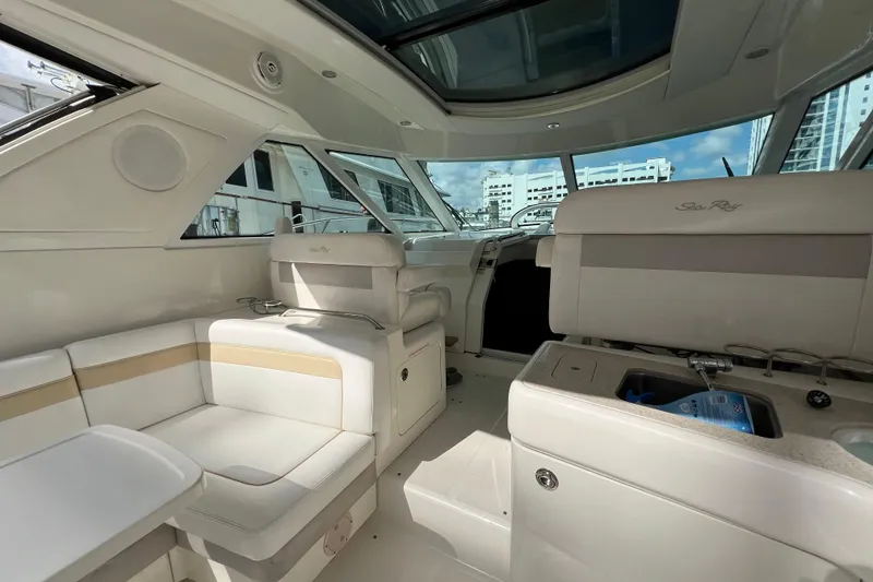 Slide: The Image of Interior of 2010 Sea Ray 450 Sundancer yacht, featuring luxurious seating and modern design. - 13
