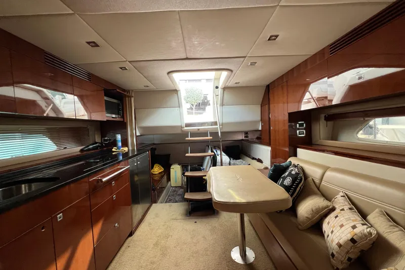 Slide: The Image of Luxurious interior of 2010 Sea Ray 450 Sundancer yacht with elegant wood finishes and cozy seating. - 15