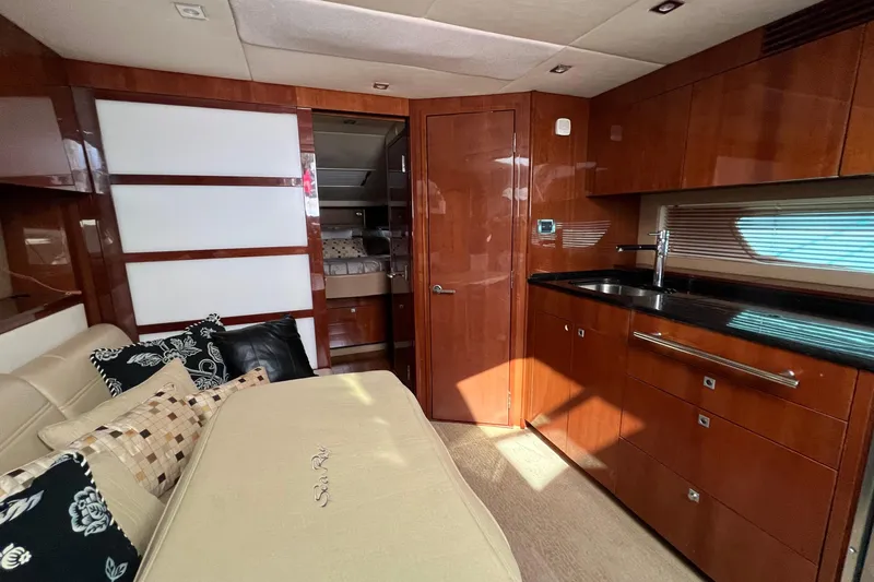 Slide: The Image of Luxurious interior of 2010 Sea Ray 450 Sundancer yacht with modern kitchen and cozy seating. - 16