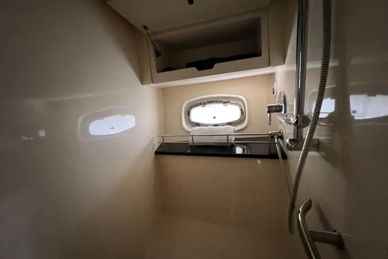 Slide: The Image of Interior of 2010 Sea Ray 450 Sundancer yacht bathroom with shower and window. - 19